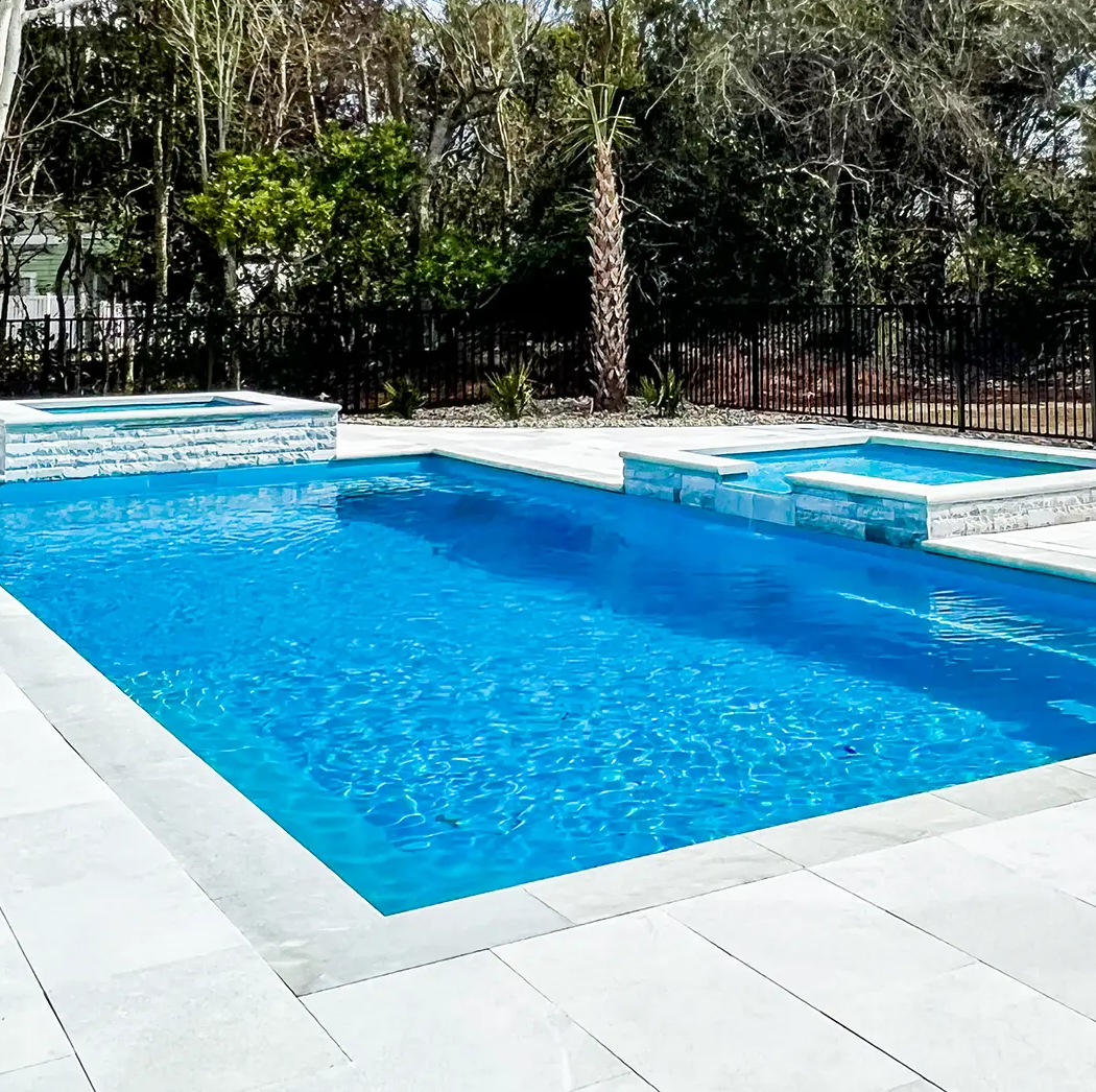 rectangular fiberglass pool with spill-over tanning ledge and spa attached