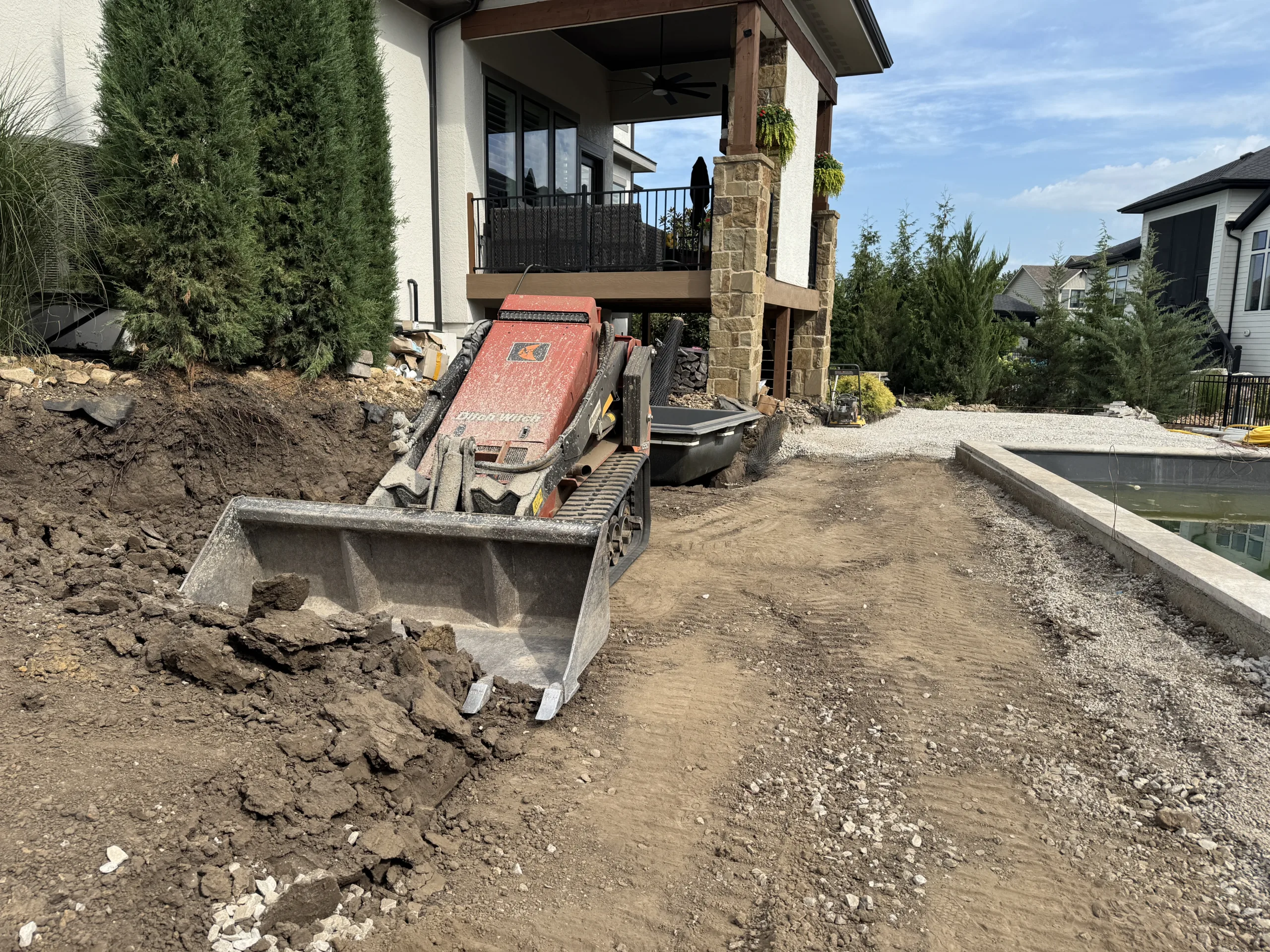 Fiberglass pool site grading in Overland Park Kansas showing clay soil preparation