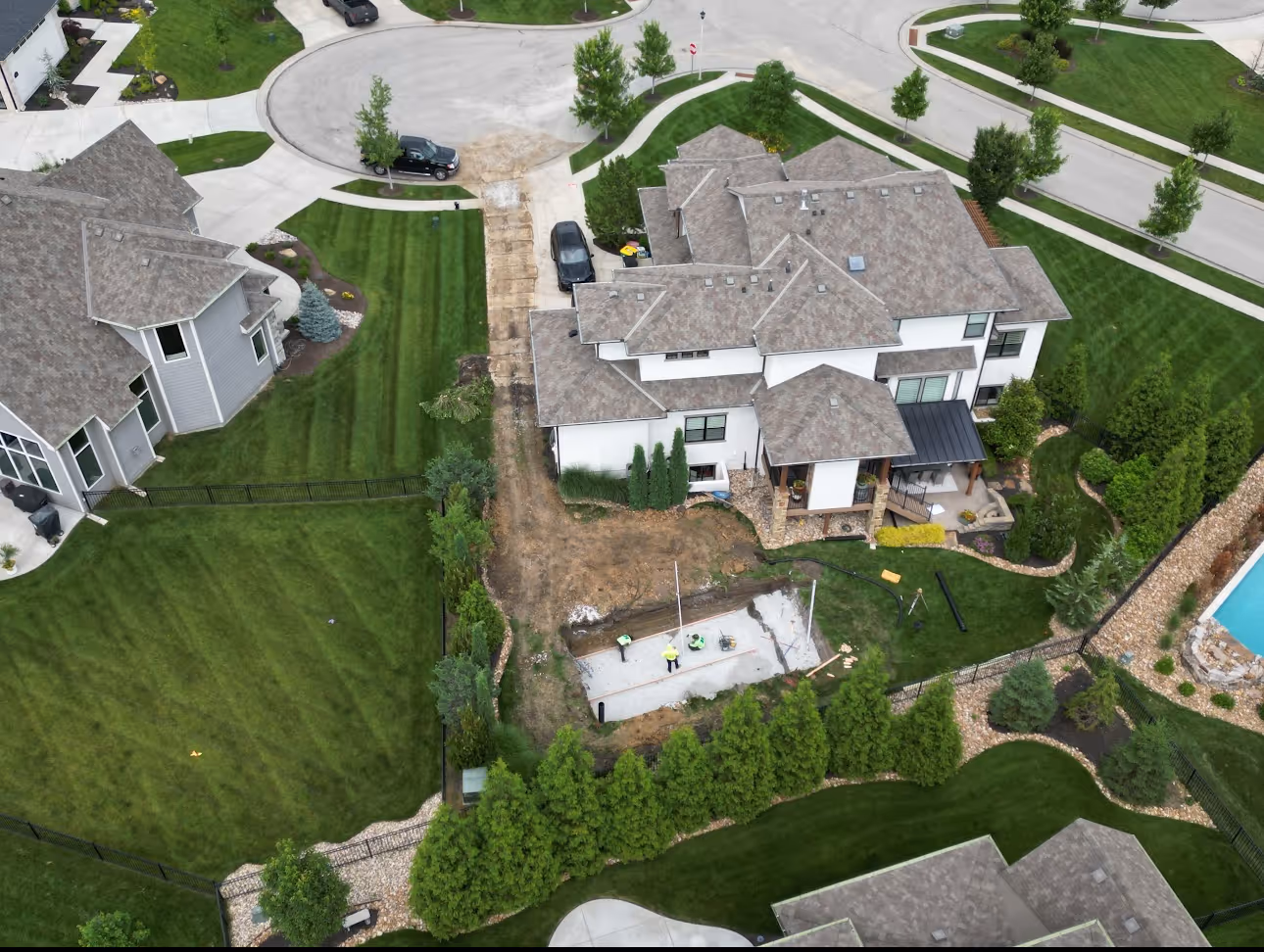 Aerial view of excavated pool hole during fiberglass pool installation in Johnson County Kansas
