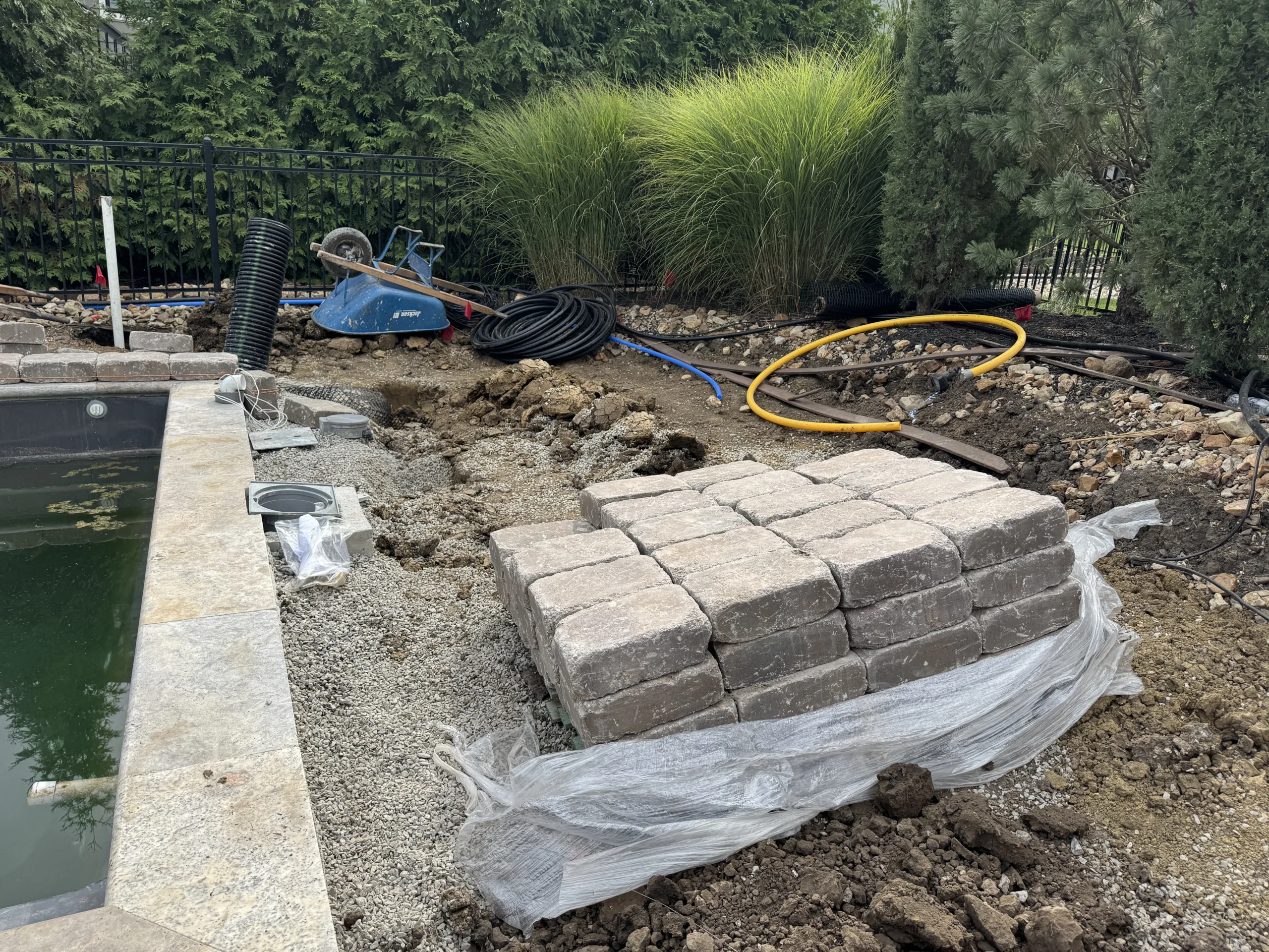 Fiberglass pool with waterfall and jumping wall feature installed in Johnson County Kansas